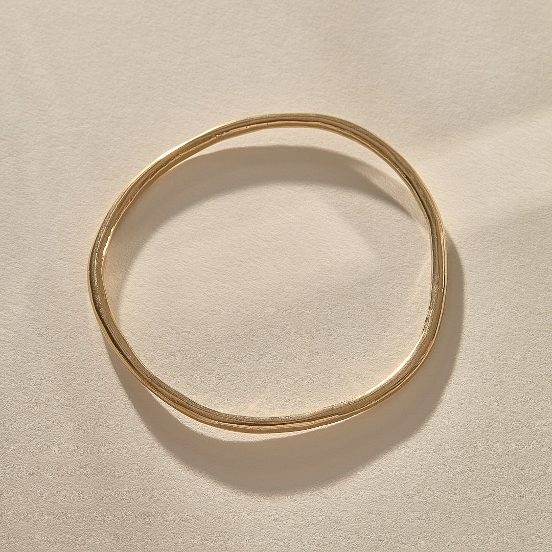 Rustic Bangle Bracelet in solid recycled gold, a single organic hand-polished bangle.