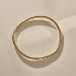 Rustic Bangle Bracelet in solid recycled gold, a single organic hand-polished bangle.