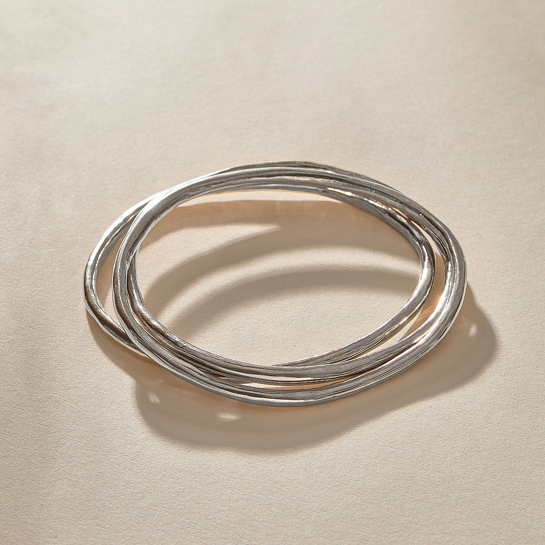 Set of 3 Rustic Bangles in sterling silver stacked together.