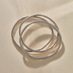Set of 3 Rustic Bangles in recycled sterling silver, three organic bands overlapping.