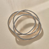Set of 3 Rustic Bangles in recycled sterling silver, three organic bands overlapping.