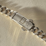 Close view of the engraved box clasp on the Sagrado Cuban Link Bracelet in sterling silver.