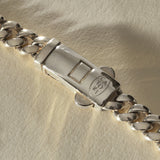 Close view of the engraved box clasp on the Sagrado Cuban Link Bracelet in sterling silver.
