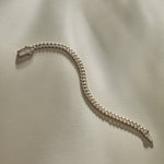 Sagrado Cuban Link Bracelet in sterling silver laid flat, showing the full length of the curb chain.