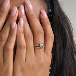 Model with her hands over her face wearing the Selkie Stack II grey diamond rings stacked on one finger.
