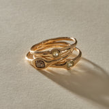 The Selkie Stack V, three one of a kind rose cut grey diamond rings in organic 10k recycled gold settings, stacked together.