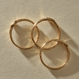 The Selkie Stack V rings from above, showing their hand-formed 10k gold bands.
