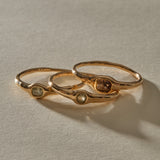 The three Selkie Stack V rings lined up side by side, each with its own natural grey diamond.