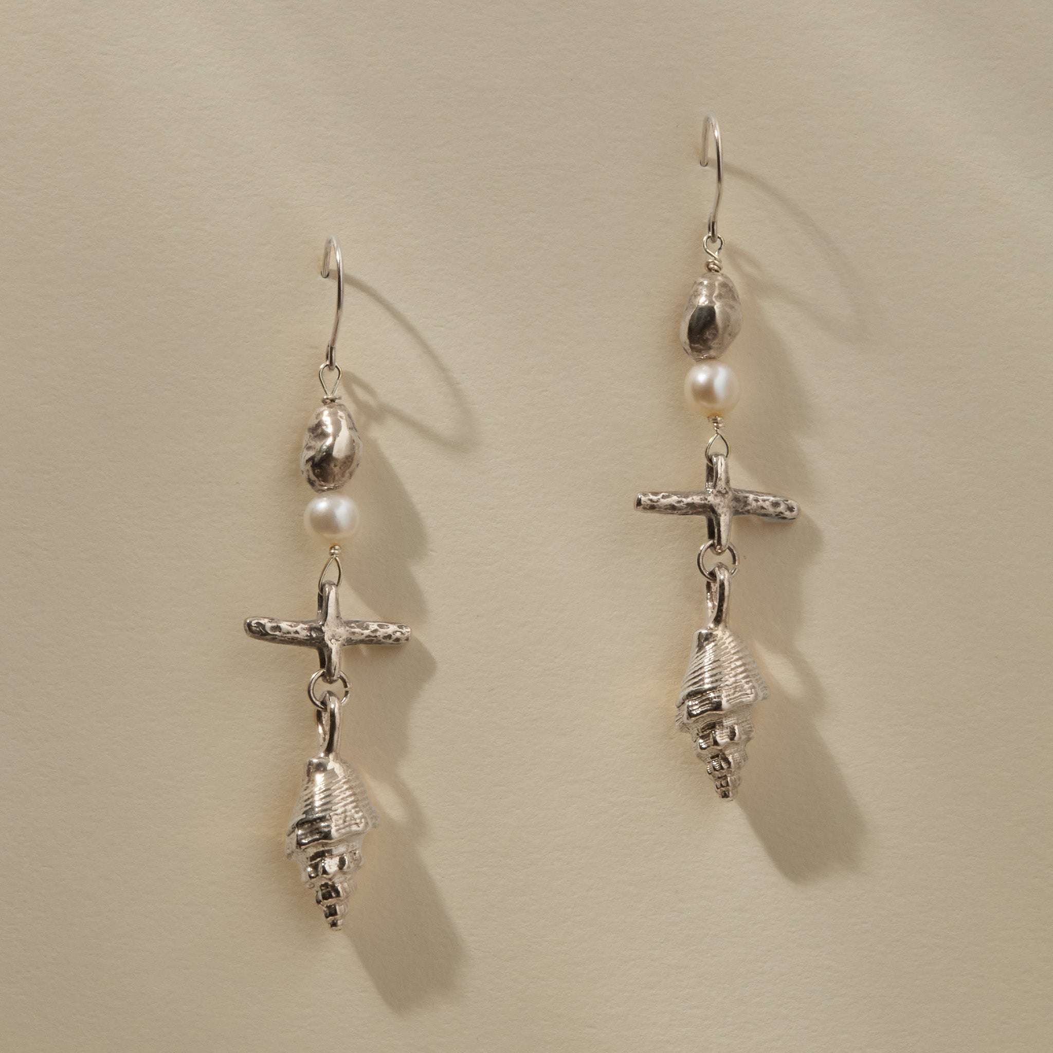 Sereia Shell and Pearl Chandelier Earrings in recycled sterling silver, a pearl and cast spiral seashell drop on silver hooks.