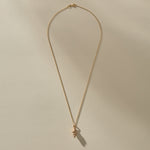 Full length of the Sereia Spiral Shell Necklace in bronze on its 20 inch chain.