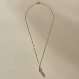 Full length of the Sereia Spiral Shell Necklace in bronze on its 20 inch chain.