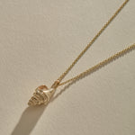 Sereia Spiral Shell Necklace in solid recycled gold, a cast spiral seashell pendant on a fine rolo chain.