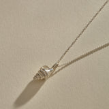 Sereia Spiral Shell Necklace in sterling silver, the shell pendant lying on its rolo chain.