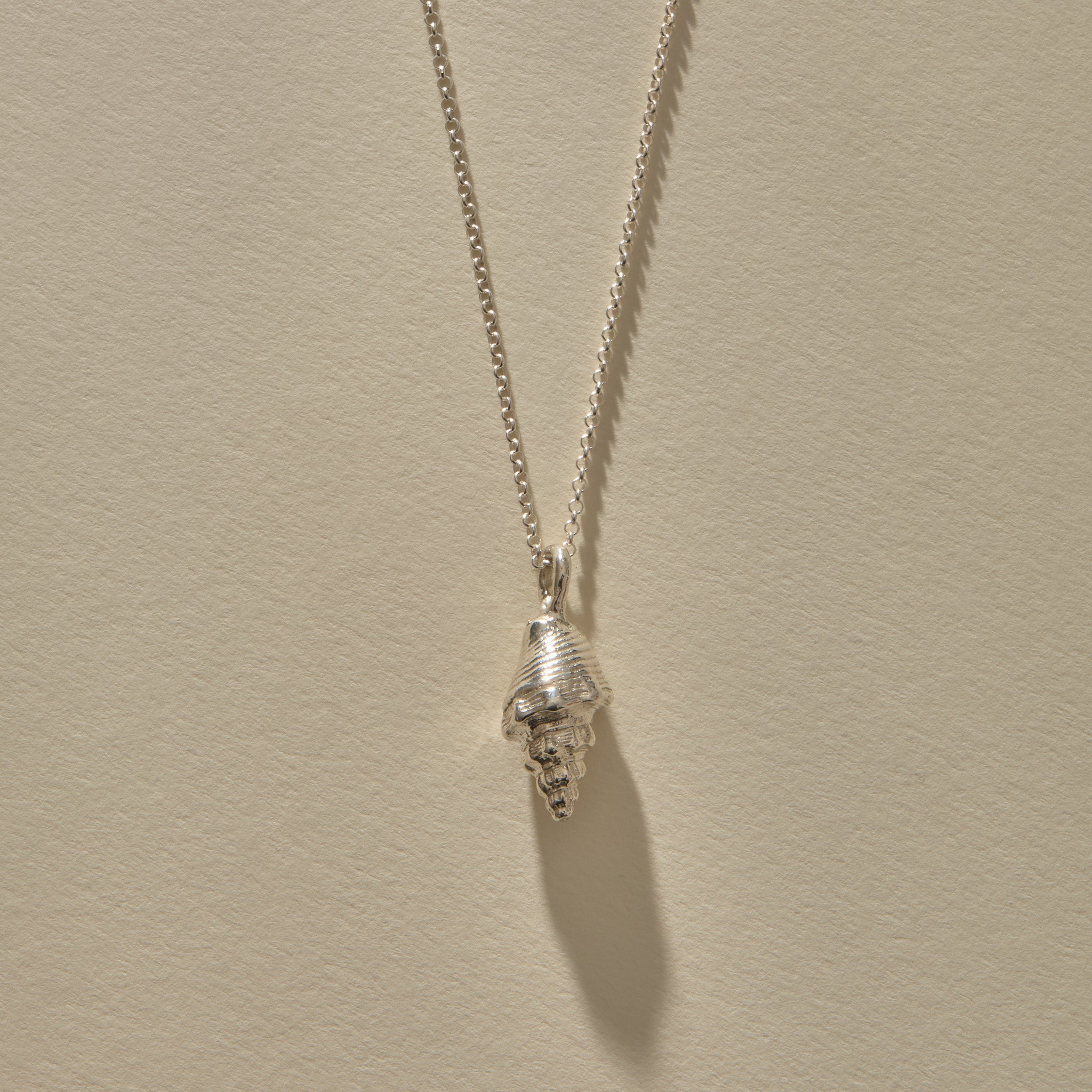 Sereia Spiral Shell Necklace in sterling silver, a close view of the ridged spiral shell.