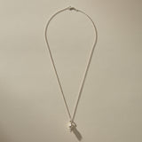 Full length of the Sereia Spiral Shell Necklace in sterling silver on its 20 inch chain.