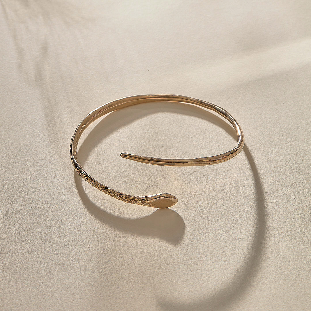 Serpent Snake Arm Cuff in bronze at an angle, showing the coiled, open design.