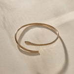 Serpent Snake Arm Cuff in bronze from above, the snake wrapping around in an open spiral.