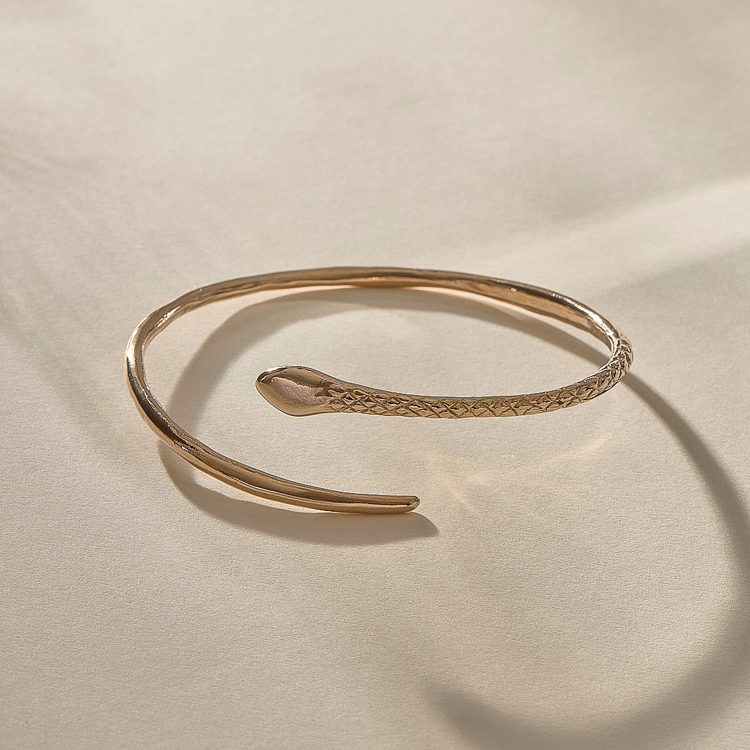 Serpent Snake Arm Cuff in recycled bronze, hand-carved with a detailed snake head and scales.