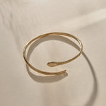 Serpent Snake Arm Cuff from the side, showing the snake head and adjustable open ends.