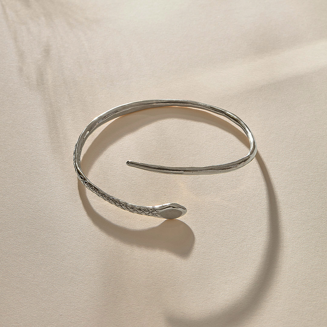 Serpent Snake Arm Cuff in sterling silver at an angle, showing the coiled, open design.