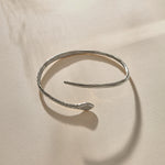 Serpent Snake Arm Cuff in sterling silver at an angle, showing the coiled, open design.