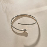 Serpent Snake Arm Cuff in sterling silver at an angle, showing the coiled, open design.