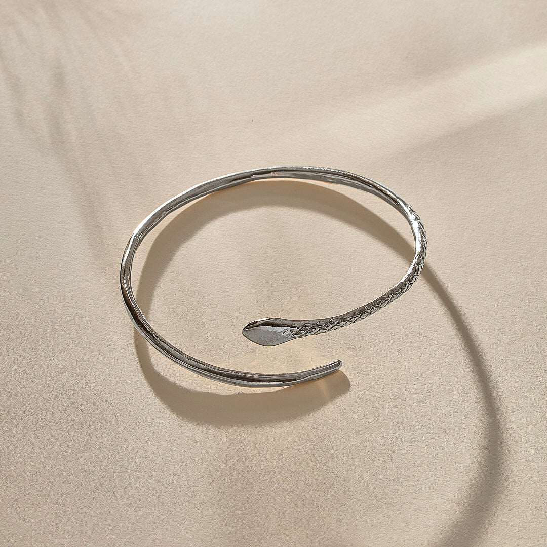 Serpent Snake Arm Cuff in sterling silver from the side, showing the snake head and open ends.