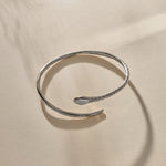 Serpent Snake Arm Cuff in sterling silver from the side, showing the snake head and open ends.
