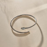 Serpent Snake Arm Cuff in sterling silver from the side, showing the snake head and open ends.