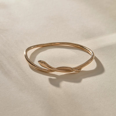 Serpent Snake Bangle in bronze at an angle, the snake coiling over the band.