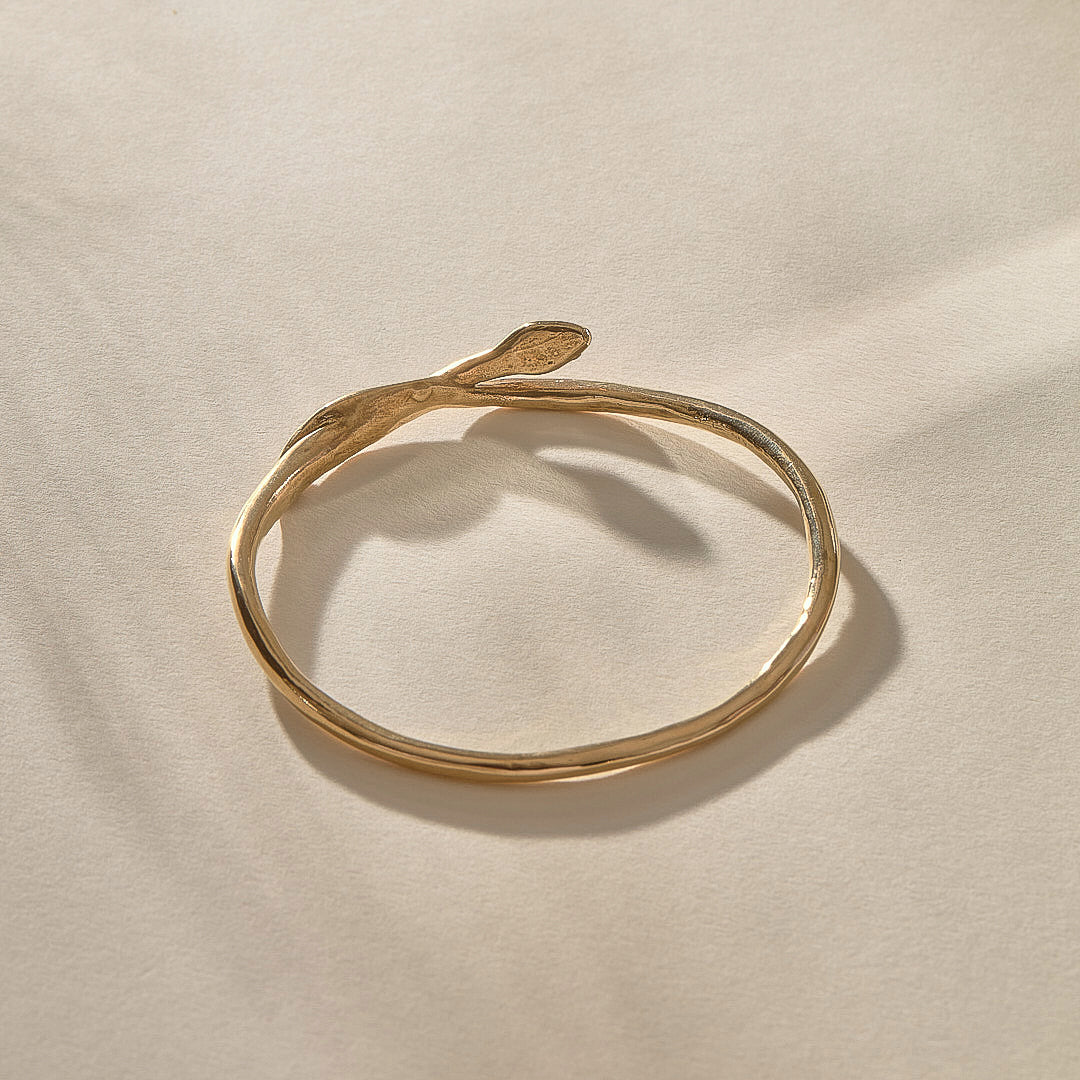 Serpent Snake Bangle in gold with the snake head raised.