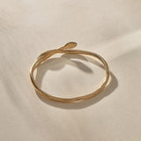 Serpent Snake Bangle in gold with the snake head raised.