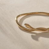 Serpent Snake Bangle Bracelet in solid recycled gold, close up on the hand-carved snake head.