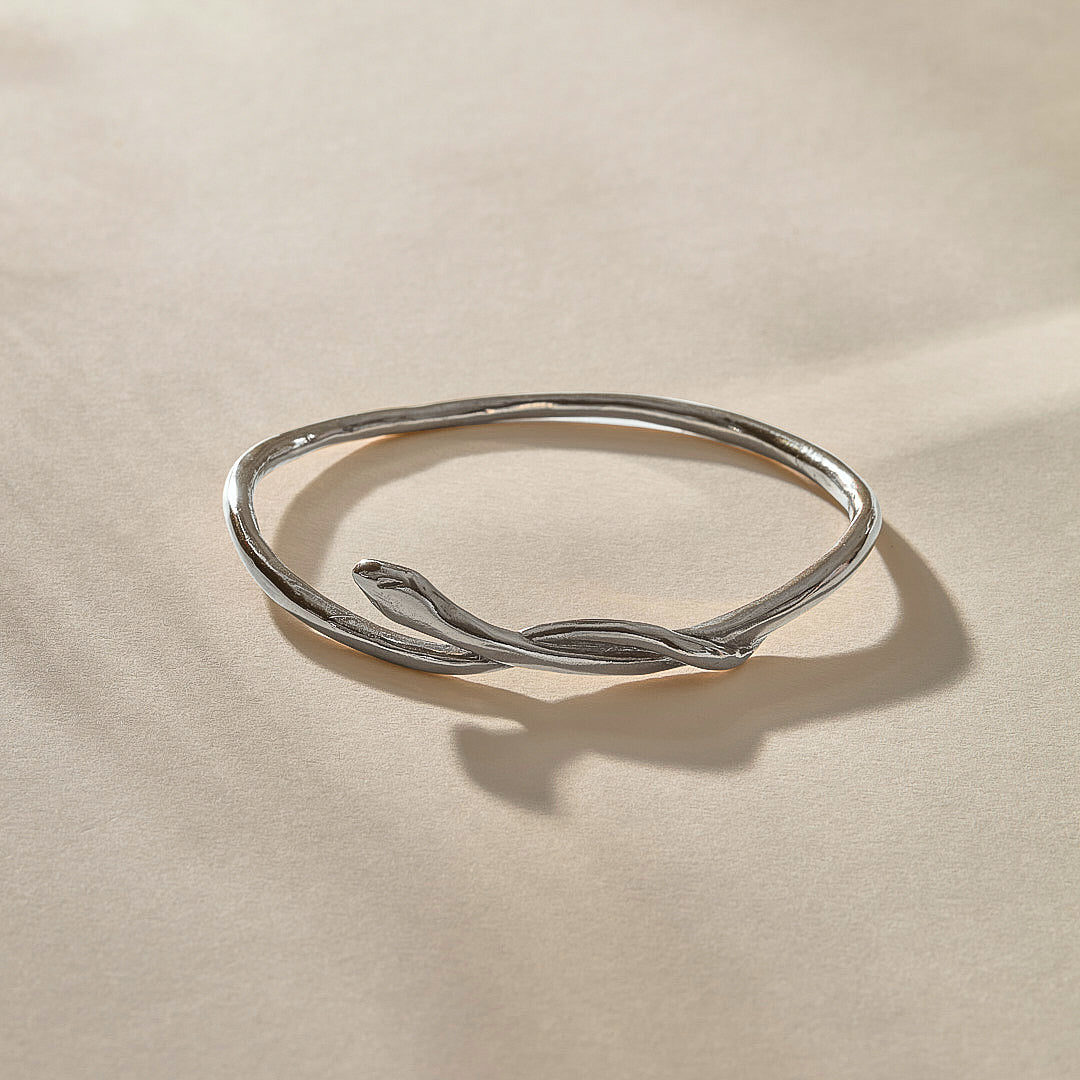 Serpent Snake Bangle in sterling silver at an angle, the snake coiling over the band.