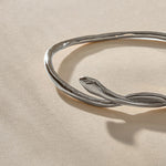 Serpent Snake Bangle Bracelet in recycled sterling silver, close up on the hand-carved snake head.