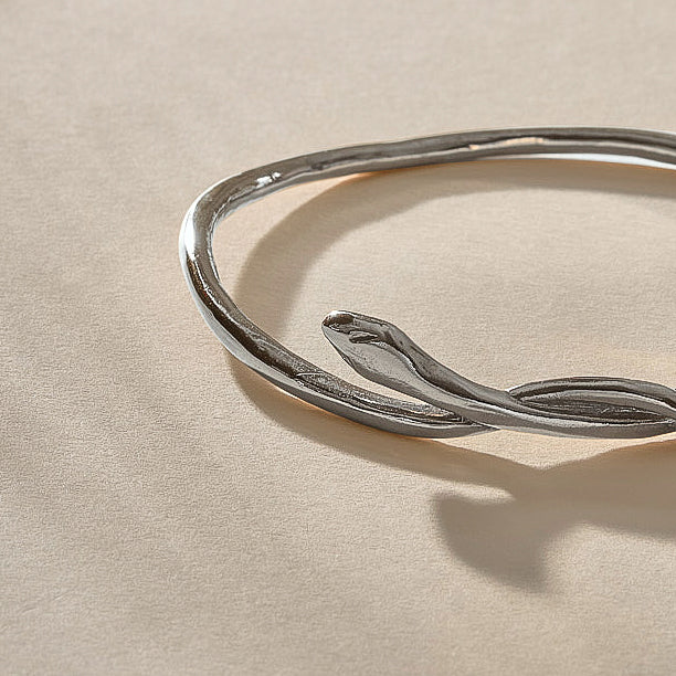 Serpent Snake Bangle Bracelet in recycled sterling silver, close up on the hand-carved snake head.