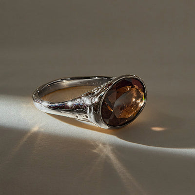 Smoky Quartz Signet Ring in recycled sterling silver, angled view with light catching the faceted stone