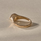 Solara citrine signet ring in solid gold from behind at an angle, with the smooth band rising to the bezel.