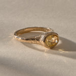 Solara citrine signet ring in gold from the side, showing the weathered, textured shoulders of the band.