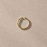 Solea Toe Ring in solid recycled gold, angled view in soft light