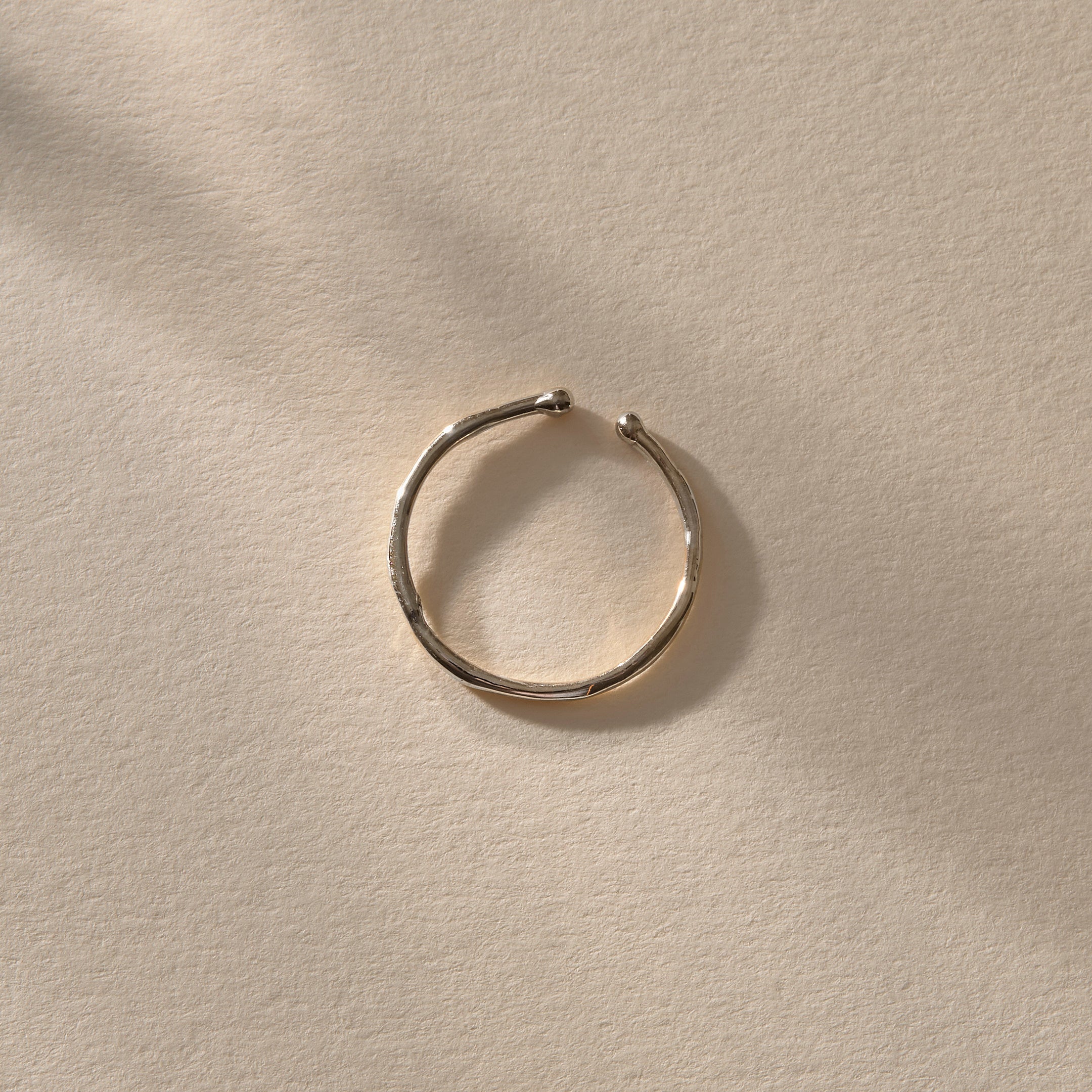 Solea Toe Ring in recycled sterling silver, view from above in soft light