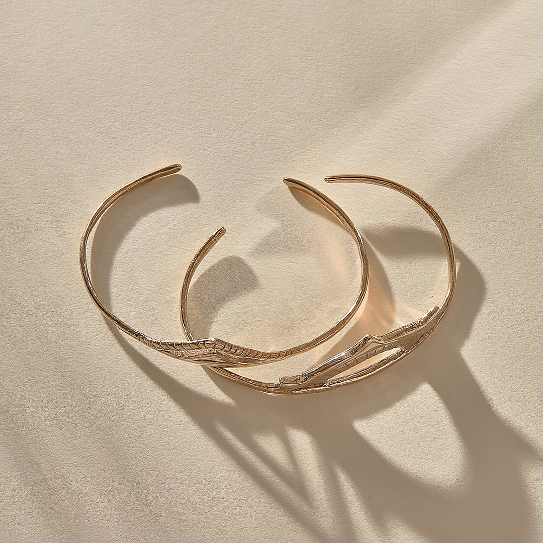 Sunkeeper and Pyramids cuffs in bronze nested together, showing the slim open bands.