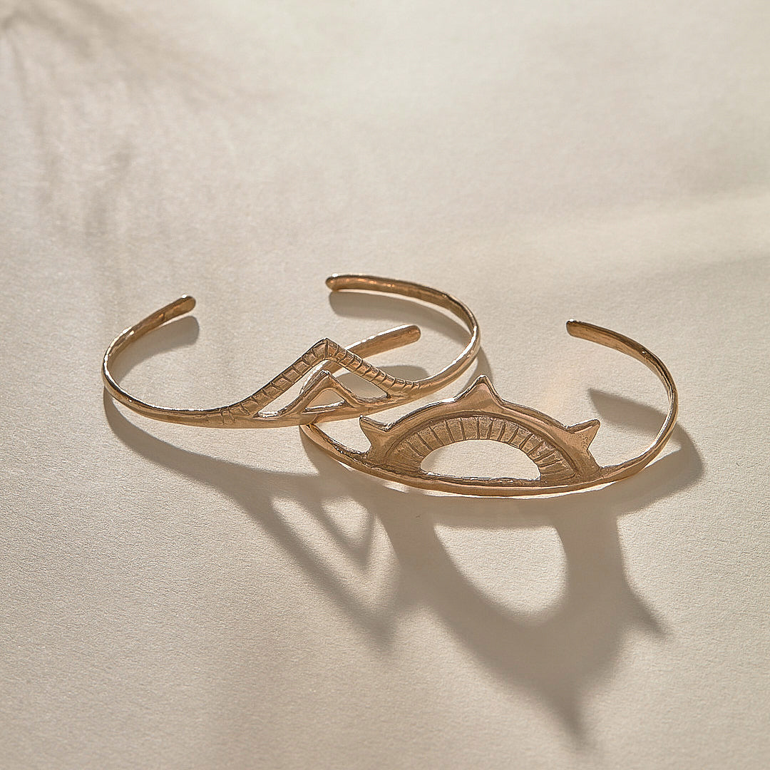 Sunkeeper and Pyramids Cuff Bracelet Set in recycled bronze, a sun cuff and a pyramid cuff laid together.
