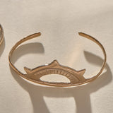 Sunkeeper Cuff in bronze, a delicate open cuff with a rising sun face.