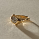 Vía Láctea I signet ring at an angle, with the smooth 14k gold band flowing around the diamond.
