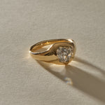 Vía Láctea I signet ring in 14k recycled gold, set with a 2.52ct polished raw salt and pepper diamond, in warm sunlight.