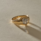 Vía Láctea I signet ring in 14k recycled gold, set with a 2.52ct polished raw salt and pepper diamond, in warm sunlight.