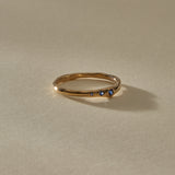 Vida Sapphire Ring, a delicate organic band in solid recycled gold set with three graduated blue sapphires, in soft sunlight.