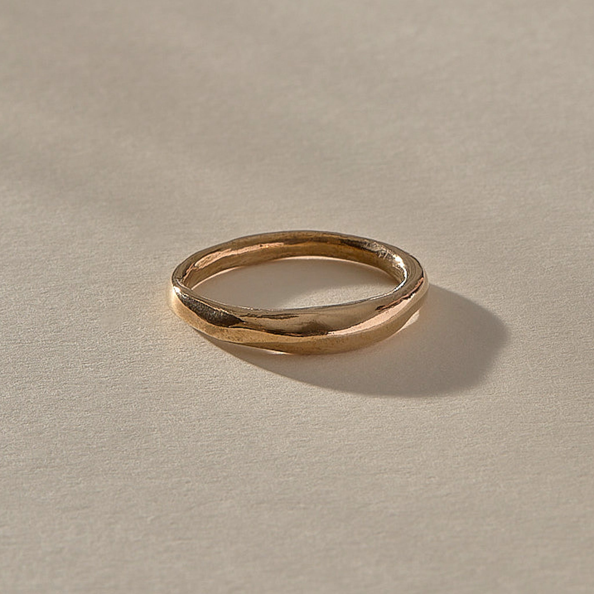 Wabi Ring in recycled bronze, angled view of the softly undulating band