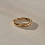 Wabi Ring in solid recycled gold, angled view of the softly undulating band